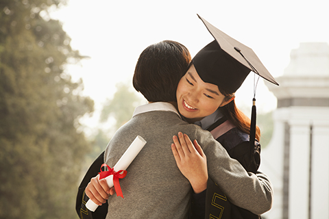 parent hugging child at graduation