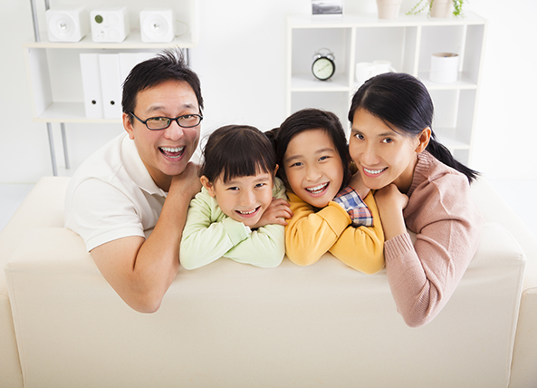 asian family of four in living room